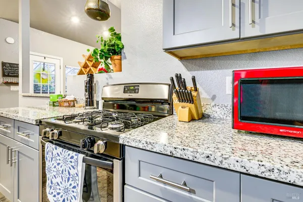 a kitchen with a table chairs and refrigerator