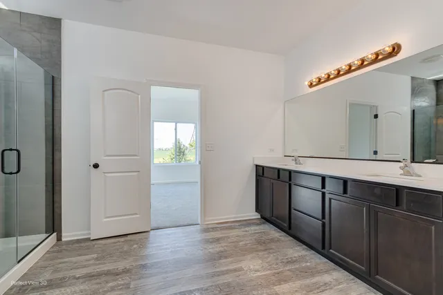 a spacious bathroom with a double vanity sink and a mirror