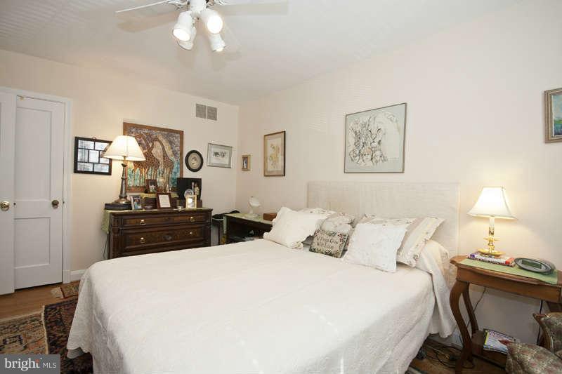 198 Stanmore Road Baltimore, MD 21212 - Photo 15 of 24 a bedroom with a bed and a lamp on dresser