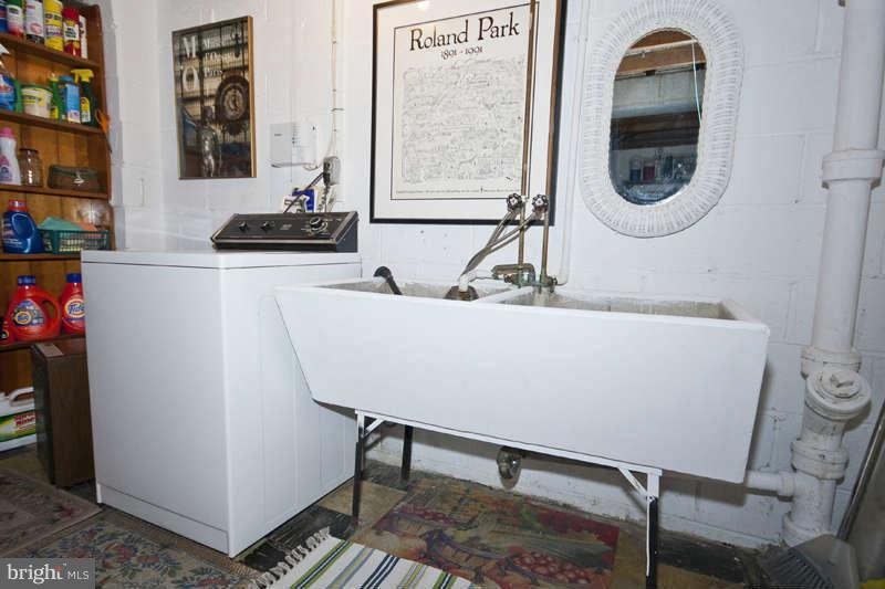 198 Stanmore Road Baltimore, MD 21212 - Photo 24 of 24 a bathroom with a sink a mirror and a window
