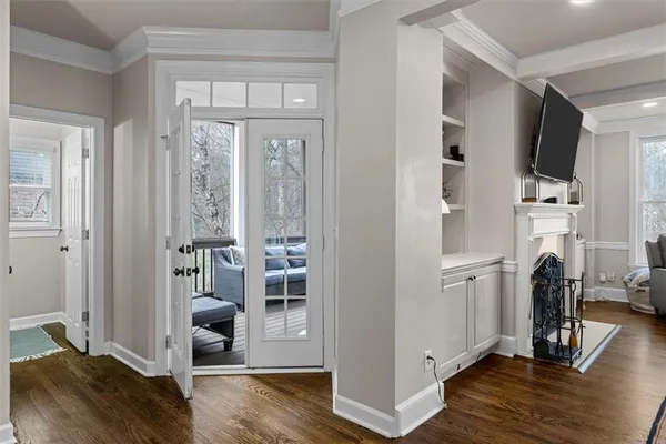 a kitchen with stainless steel appliances granite countertop a sink a stove a refrigerator and white cabinets