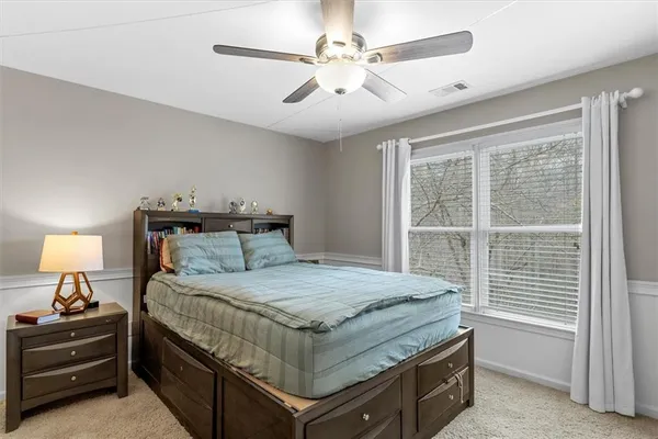 a living room with furniture a flat screen tv and a window