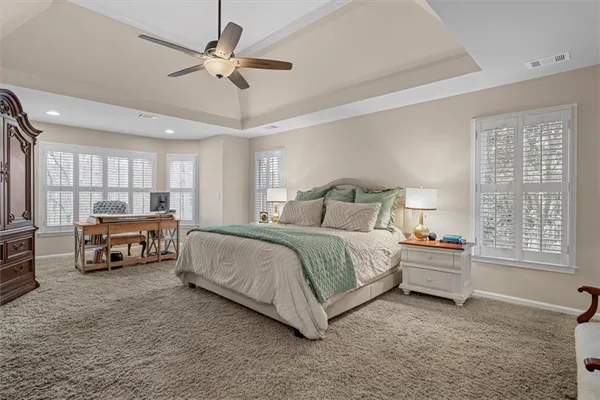 a bedroom with a bed and a lamp on table