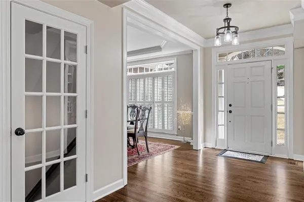 a view of a room with wooden floor and windows