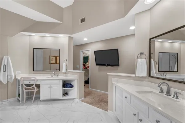 a view of a patio with table and chairs potted plants and large tree