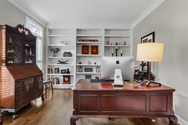 a room with furniture a rug and a book shelf