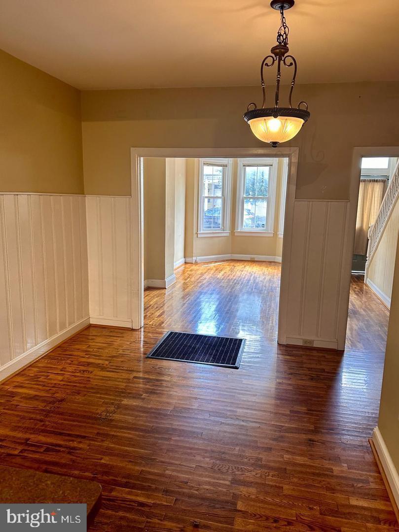 313 North Kent Street Winchester, VA 22601 - Photo 4 of 15 a view of an empty room with wooden floor and a window
