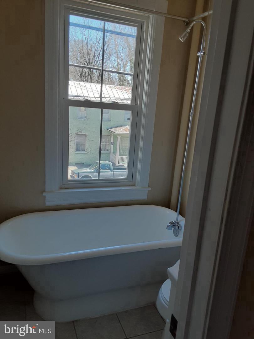 313 North Kent Street Winchester, VA 22601 - Photo 6 of 15 a bath tub sitting next to a window