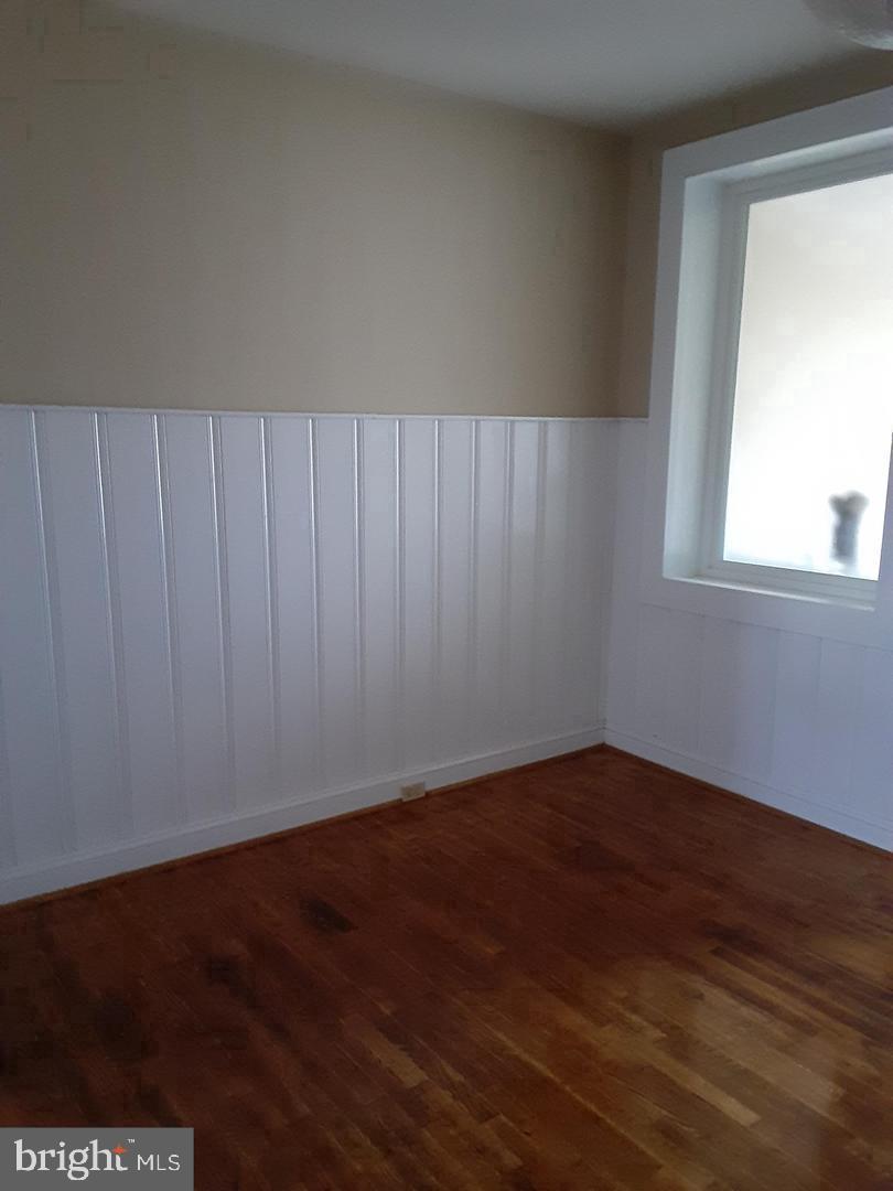 313 North Kent Street Winchester, VA 22601 - Photo 8 of 15 a view of an empty room with wooden floor and a window