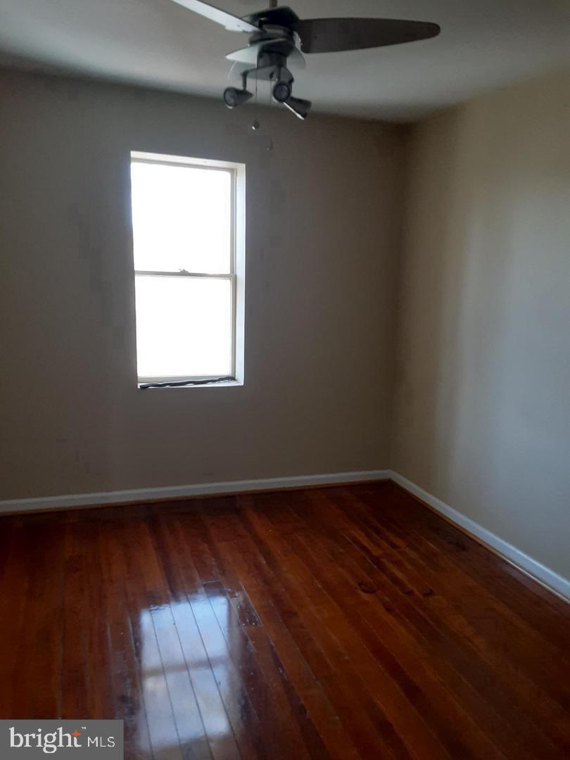 313 North Kent Street Winchester, VA 22601 - Photo 10 of 15 an empty room with wooden floor windows and fan