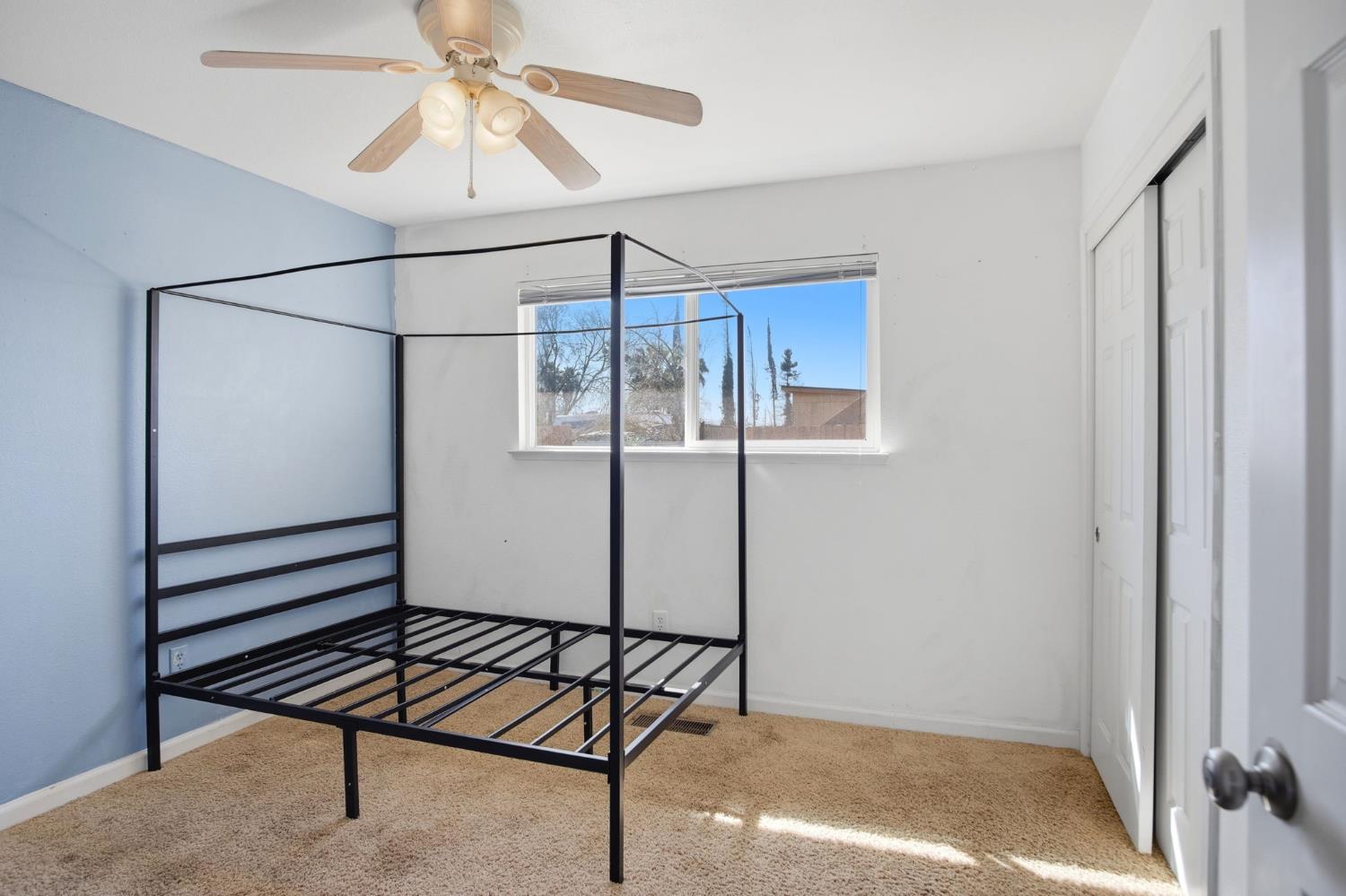 1409 Stonum Road Modesto, CA 95351 - Photo 18 of 40 a view of a room with wooden floor and a chandelier fan