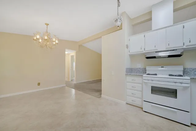 a kitchen with cabinets appliances and a fireplace