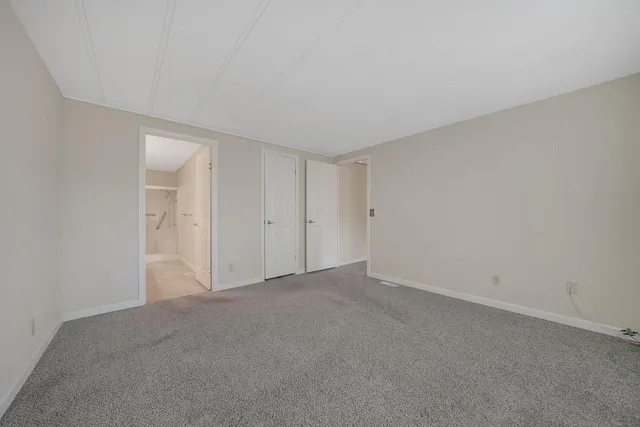 a view of an empty room and closet area