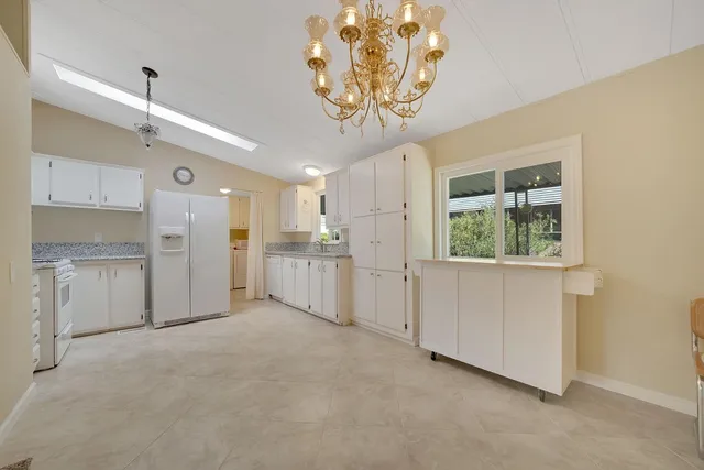 a view of a kitchen with a sink and cabinets