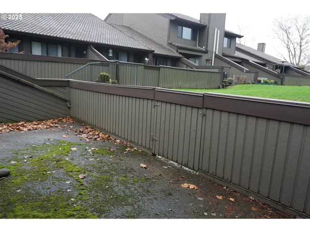 a backyard of a house with table and chairs