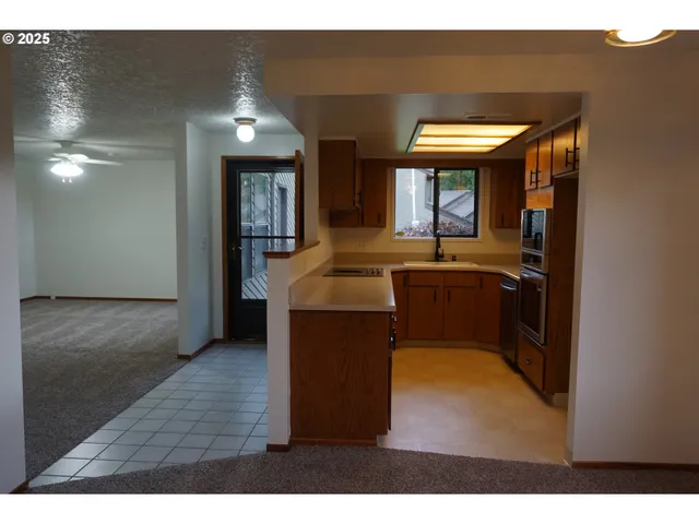 a kitchen with sink and cabinets
