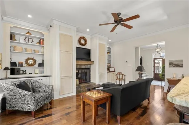 a living room with furniture a rug and a flat screen tv