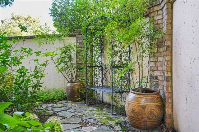 a bathroom with a granite countertop sink a toilet a mirror and bathtub