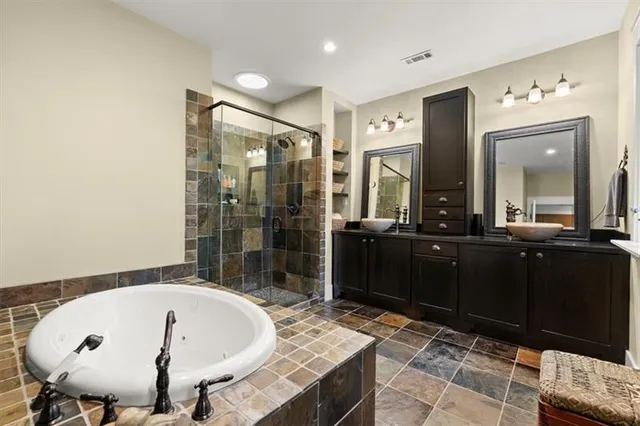 a front view of a house with a garden and plants