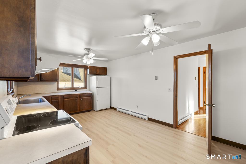 16 Harold Avenue Greenwich, CT 06830 - Photo 11 of 14 a bedroom with a bed and a chandelier