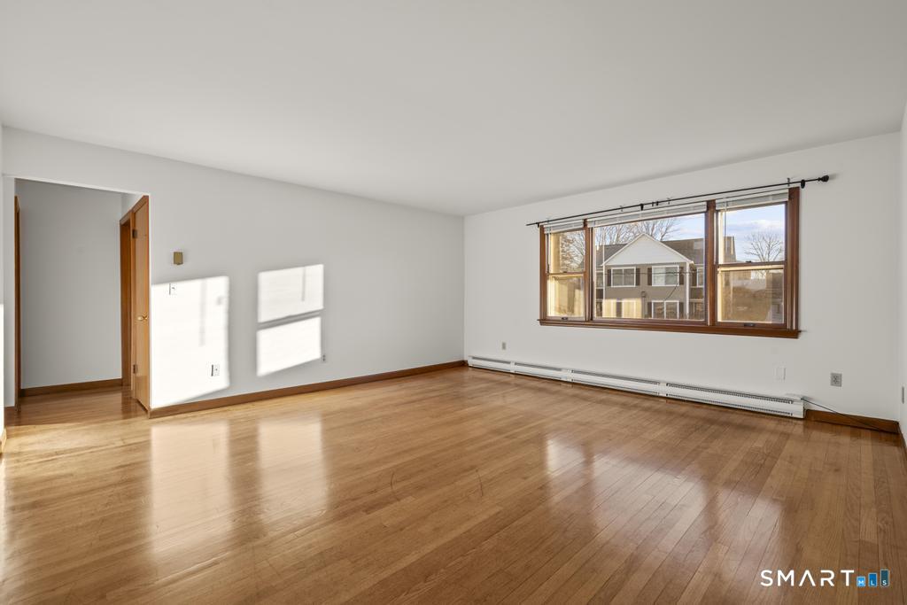 16 Harold Avenue Greenwich, CT 06830 - Photo 4 of 14 a view of an empty room with window and wooden floor