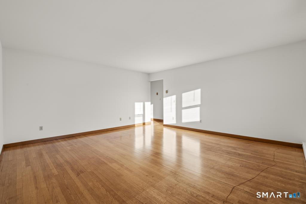 16 Harold Avenue Greenwich, CT 06830 - Photo 5 of 14 a view of empty room with wooden floor and fan