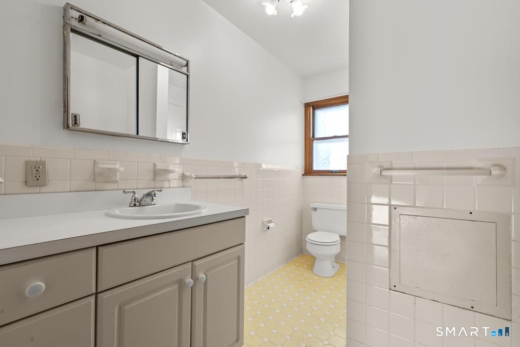 16 Harold Avenue Greenwich, CT 06830 - Photo 10 of 14 a bathroom with a toilet sink and mirror