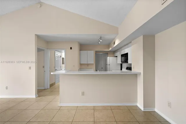 a kitchen with stainless steel appliances a sink and cabinets