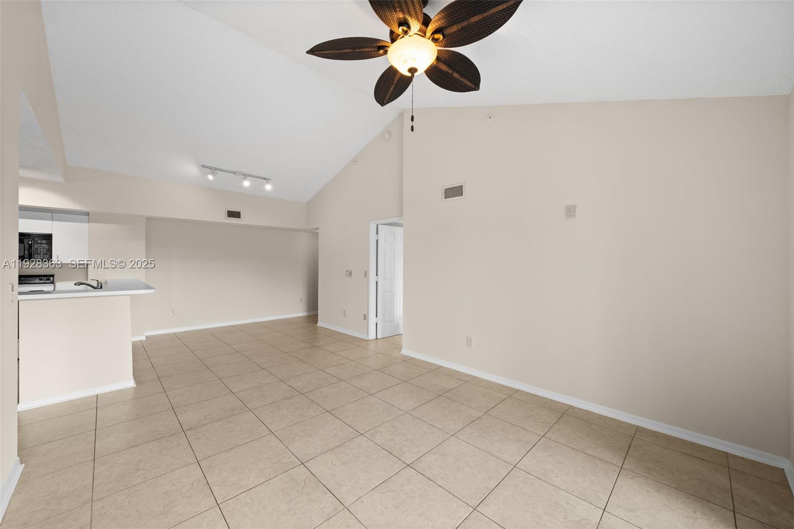 2600 South University Drive, Unit 326 Davie, FL 33328 - Photo 6 of 22 a view of an empty room and kitchen view