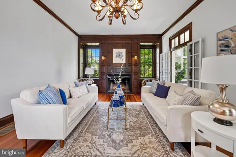 a living room with furniture and a chandelier