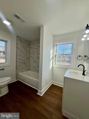 a bathroom with a sink and a large mirror