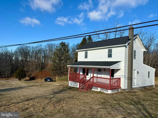 a view of a house with backyard porch and wooden fence