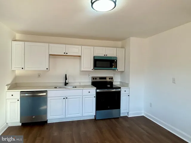 a kitchen with a sink cabinets and stainless steel appliances