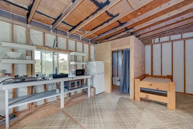 a view of a room with wooden floor and a carpet