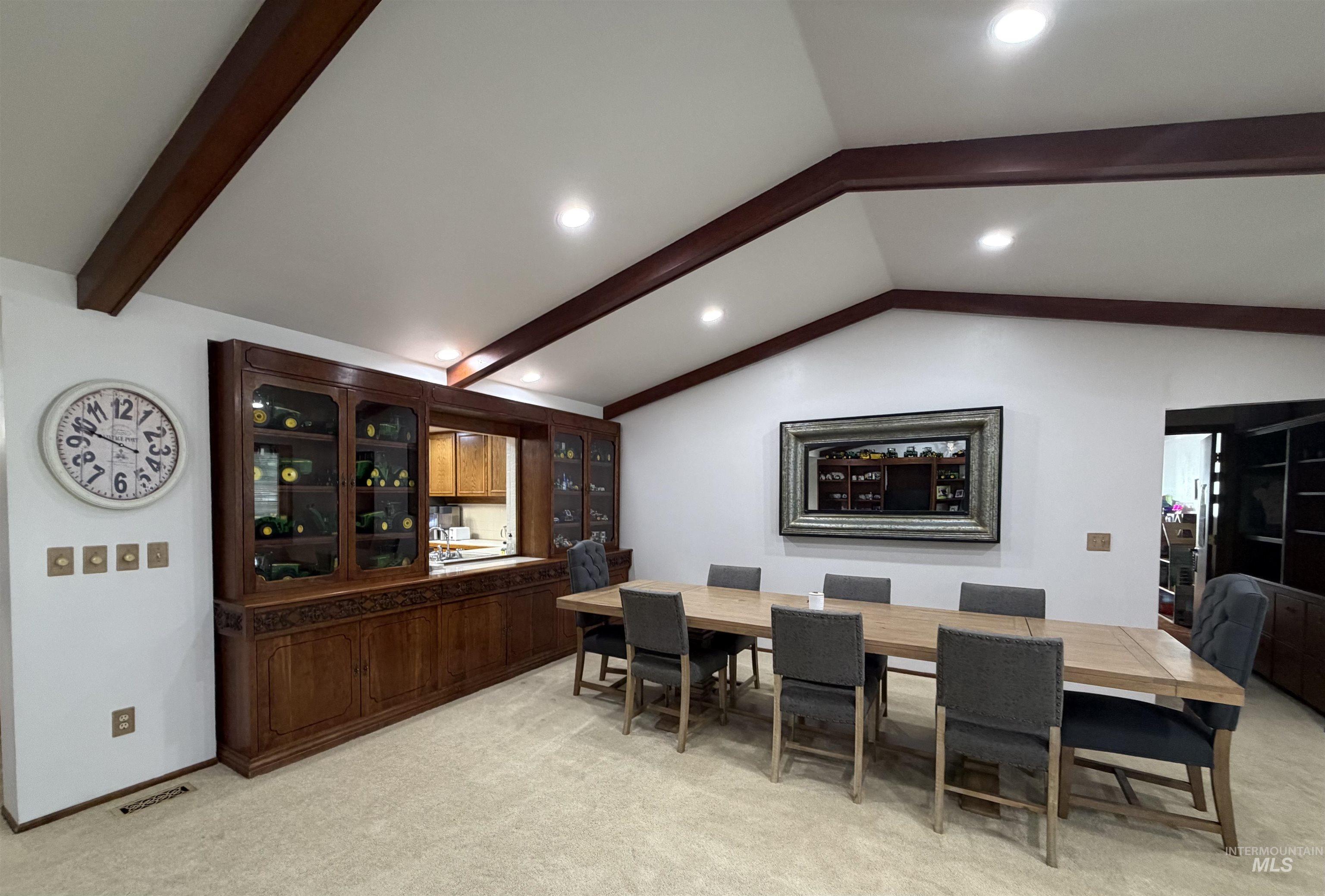 880 Jenkins Creek Road Weiser, ID 83672 - Photo 11 of 43 Vaulted ceiling with exposed wood beams, recessed lighting, and a built-in wood display cabinet featuring glass doors and carved details