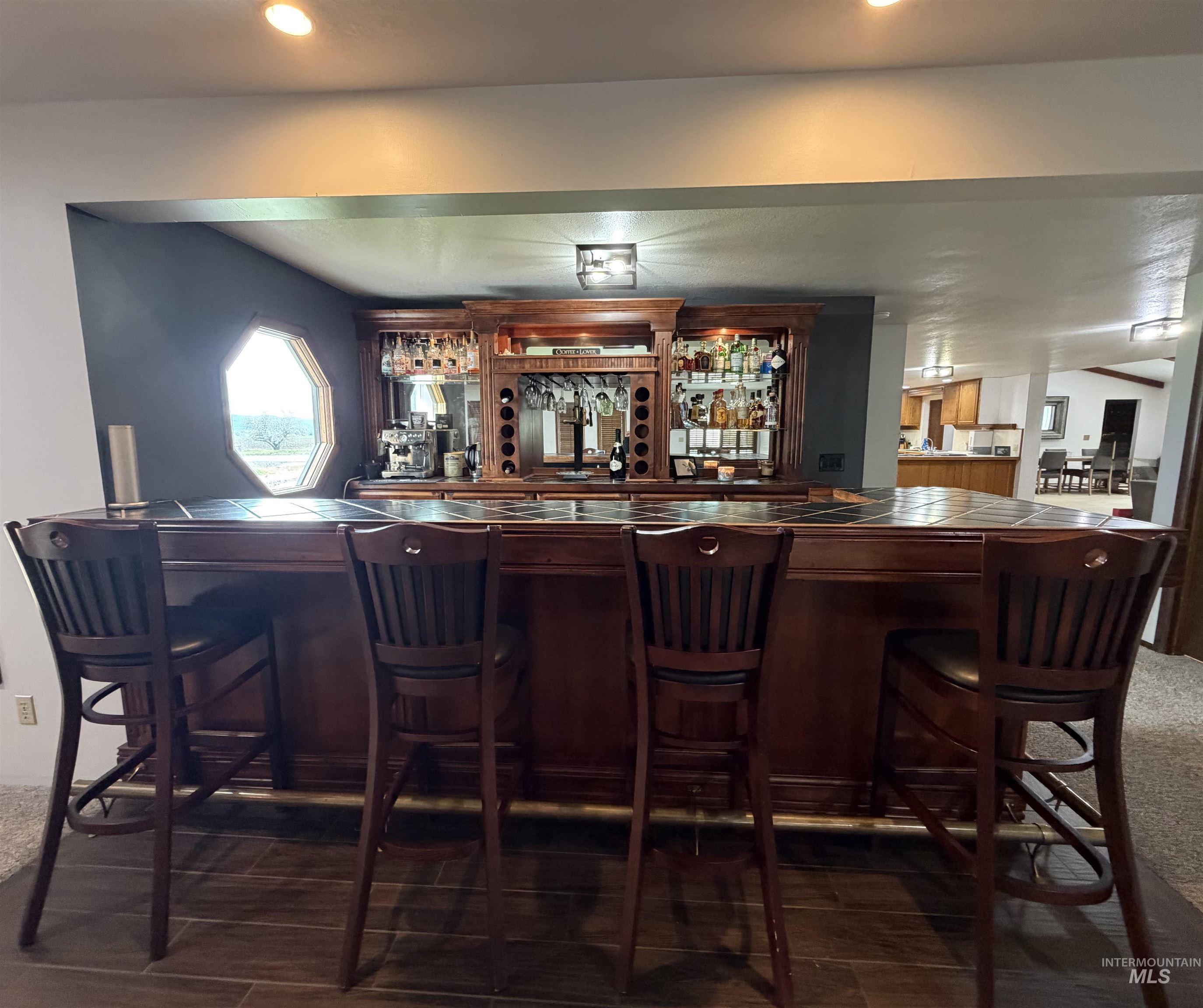 880 Jenkins Creek Road Weiser, ID 83672 - Photo 13 of 43 Custom-built wood bar with integrated shelving, glass racks, and wine storage