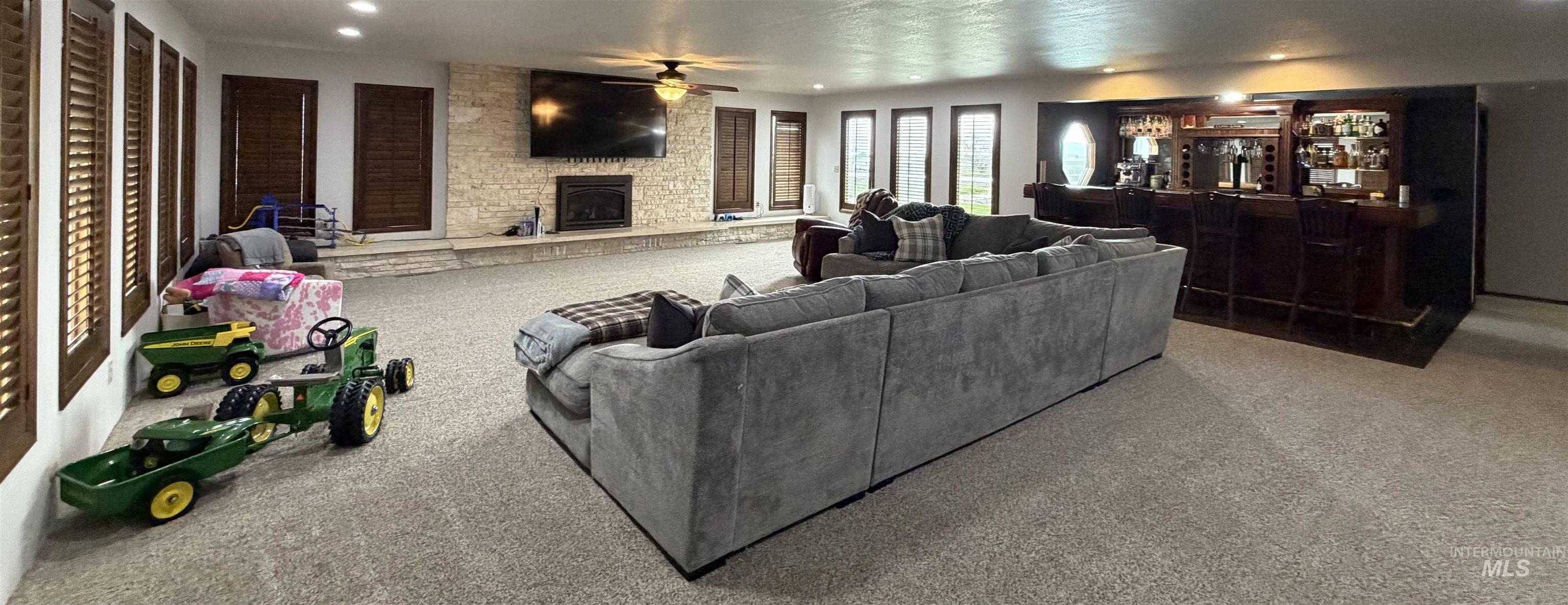 880 Jenkins Creek Road Weiser, ID 83672 - Photo 14 of 43 Spacious entertainment area featuring recessed lighting, a stone-clad fireplace, and a full-service wet bar