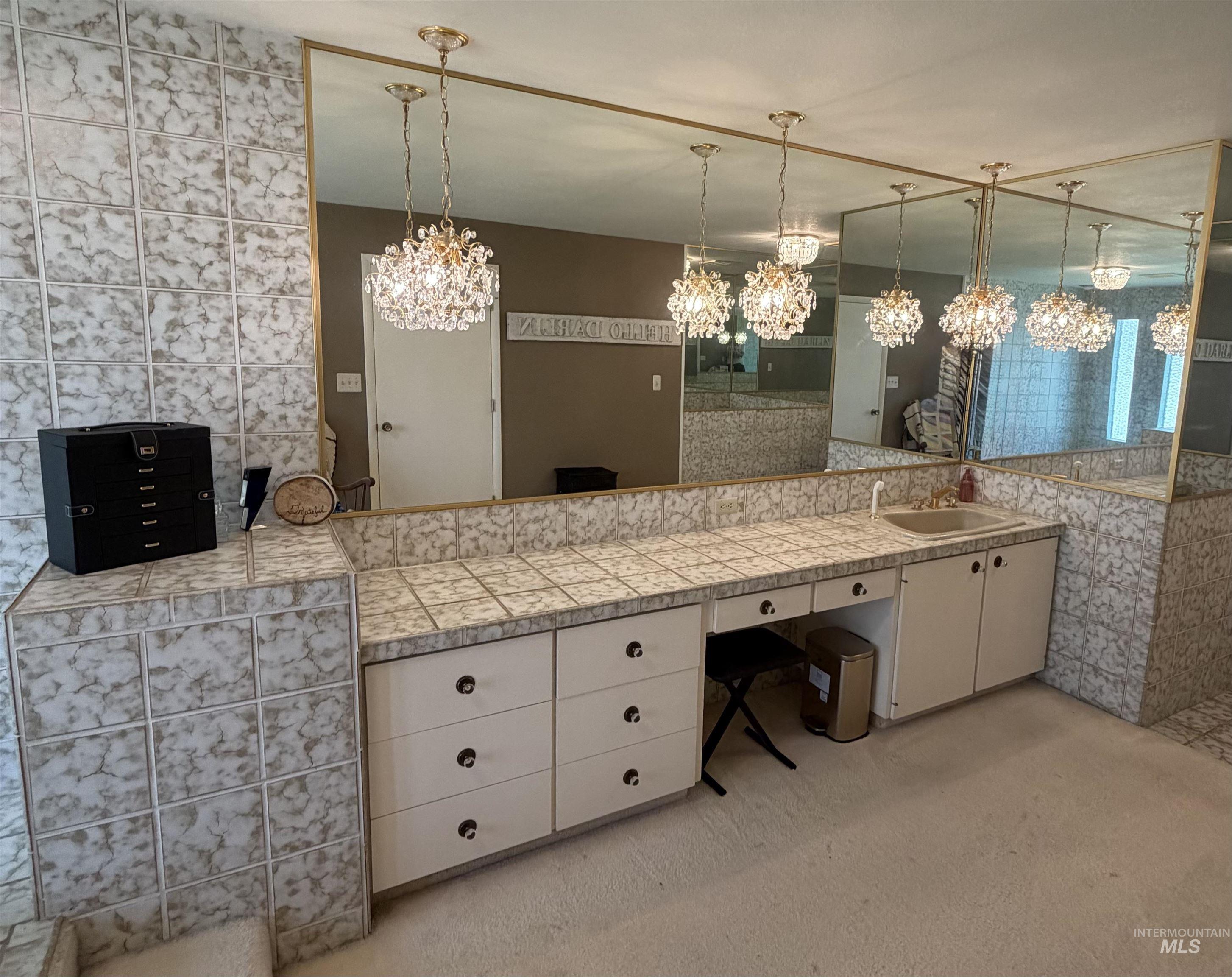 880 Jenkins Creek Road Weiser, ID 83672 - Photo 18 of 43 Vanity area featuring an integrated sink, extensive counter space with tiled surfaces, and multiple base cabinets with drawers