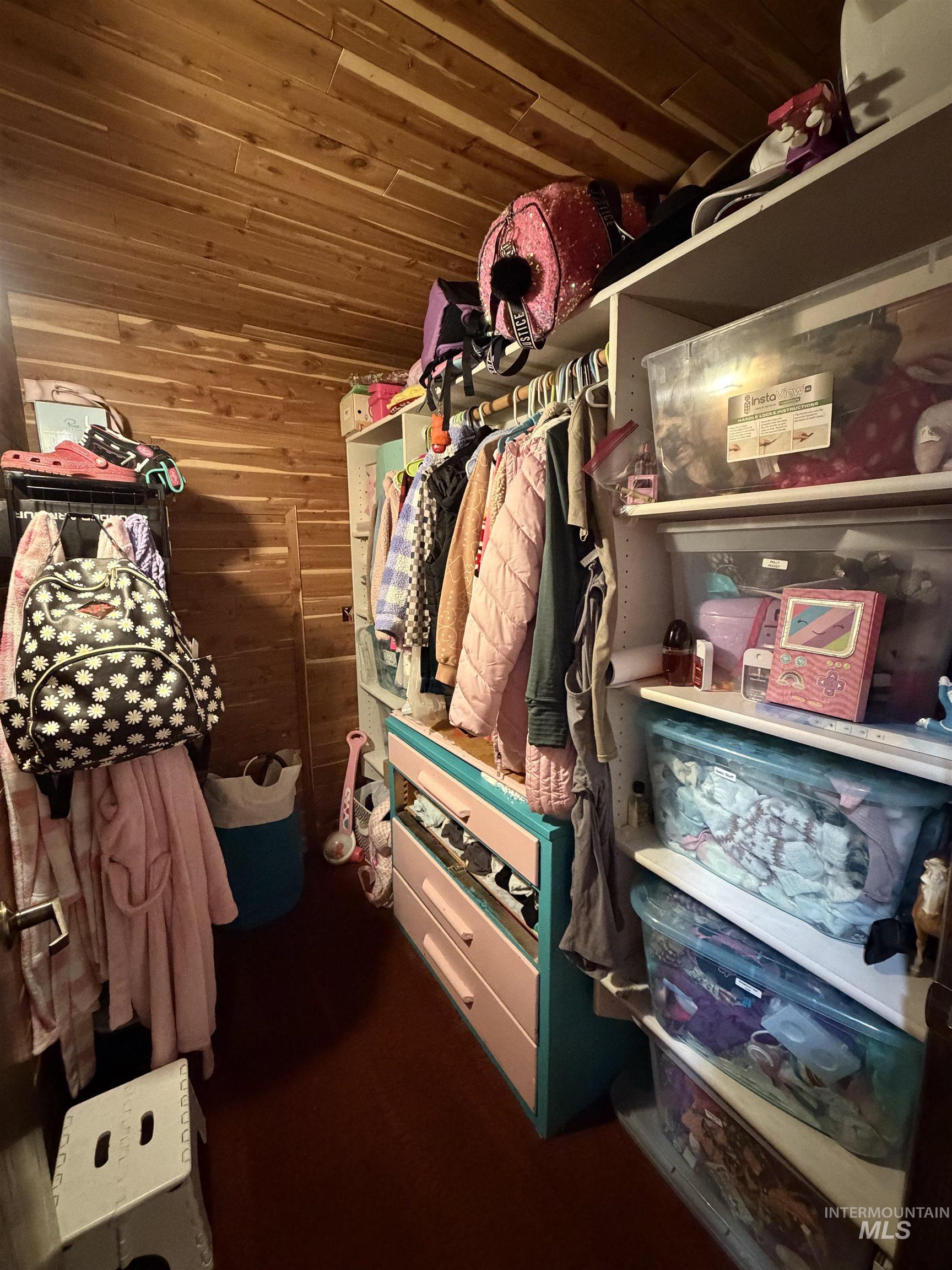 880 Jenkins Creek Road Weiser, ID 83672 - Photo 27 of 43 Custom closet space featuring cedar plank walls and ceiling, built-in shelving, hanging rods, and an integrated drawer unit