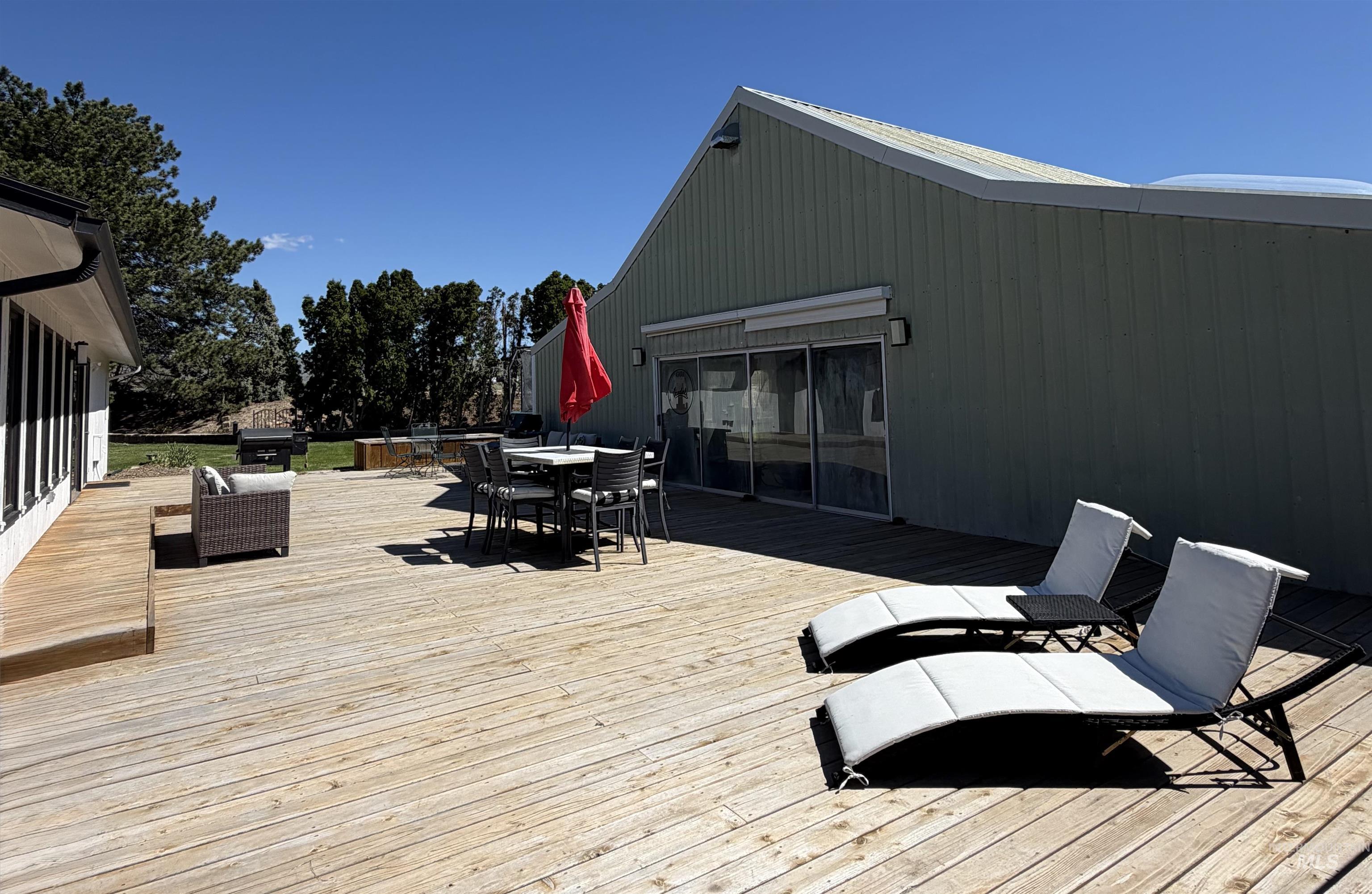 880 Jenkins Creek Road Weiser, ID 83672 - Photo 39 of 43 Expansive wood deck with a partial elevated section, offering multiple areas for outdoor activities