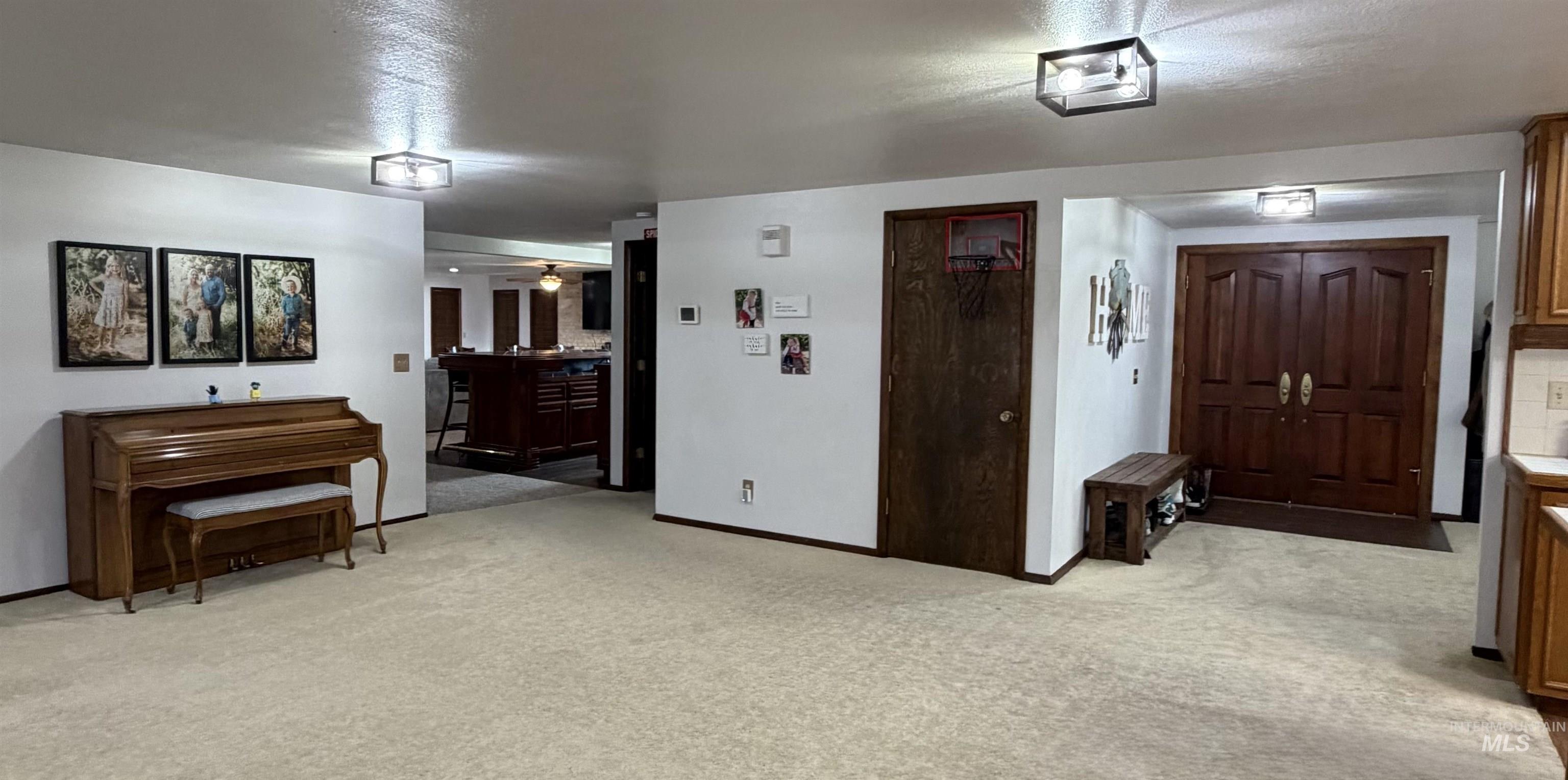 880 Jenkins Creek Road Weiser, ID 83672 - Photo 6 of 43 Expansive carpeted area featuring a double-door entry with wood panels, recessed ceiling lights, and wood trim details