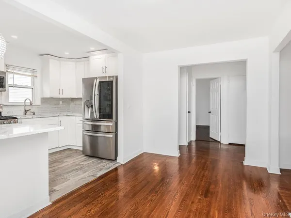 a kitchen with a refrigerator and a stove top oven