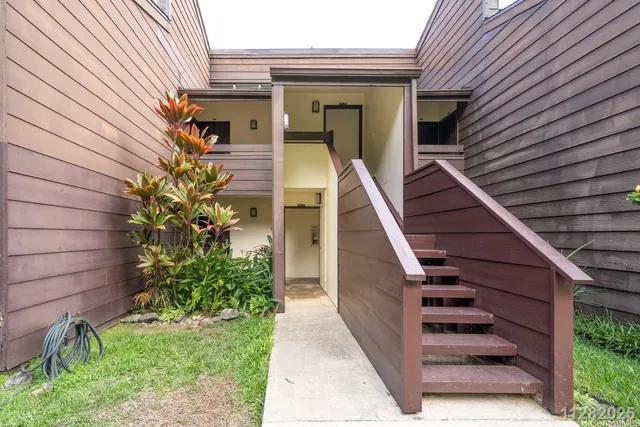 a view of a pathway of a house with wooden walls and stairs