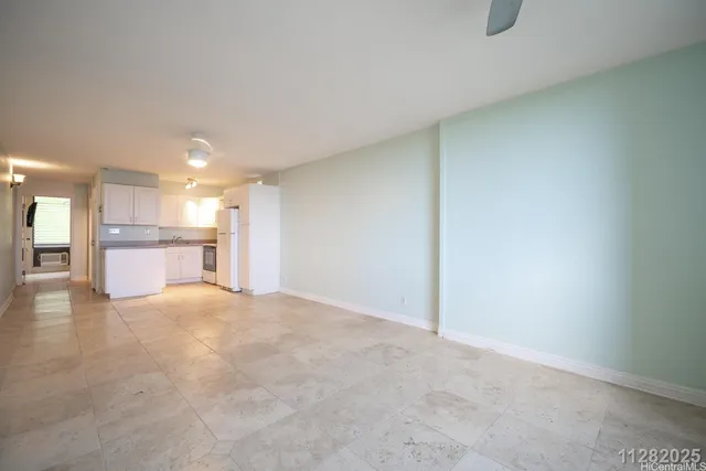 a view of a kitchen with a sink and a refrigerator
