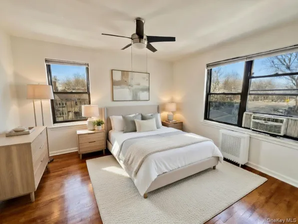 a bedroom with a large bed and a large window
