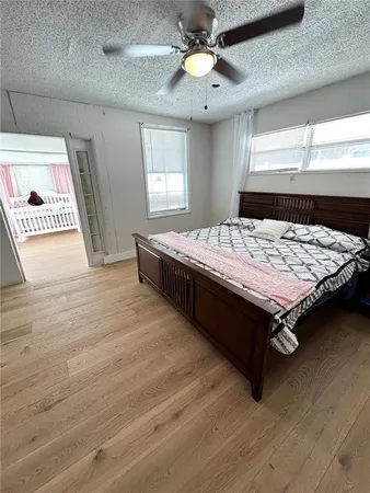 a bed sitting in a spacious bedroom next to a window