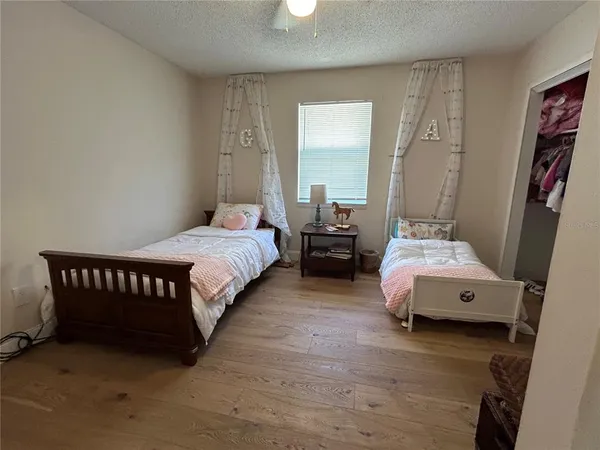 a spacious bedroom with a bed and a window