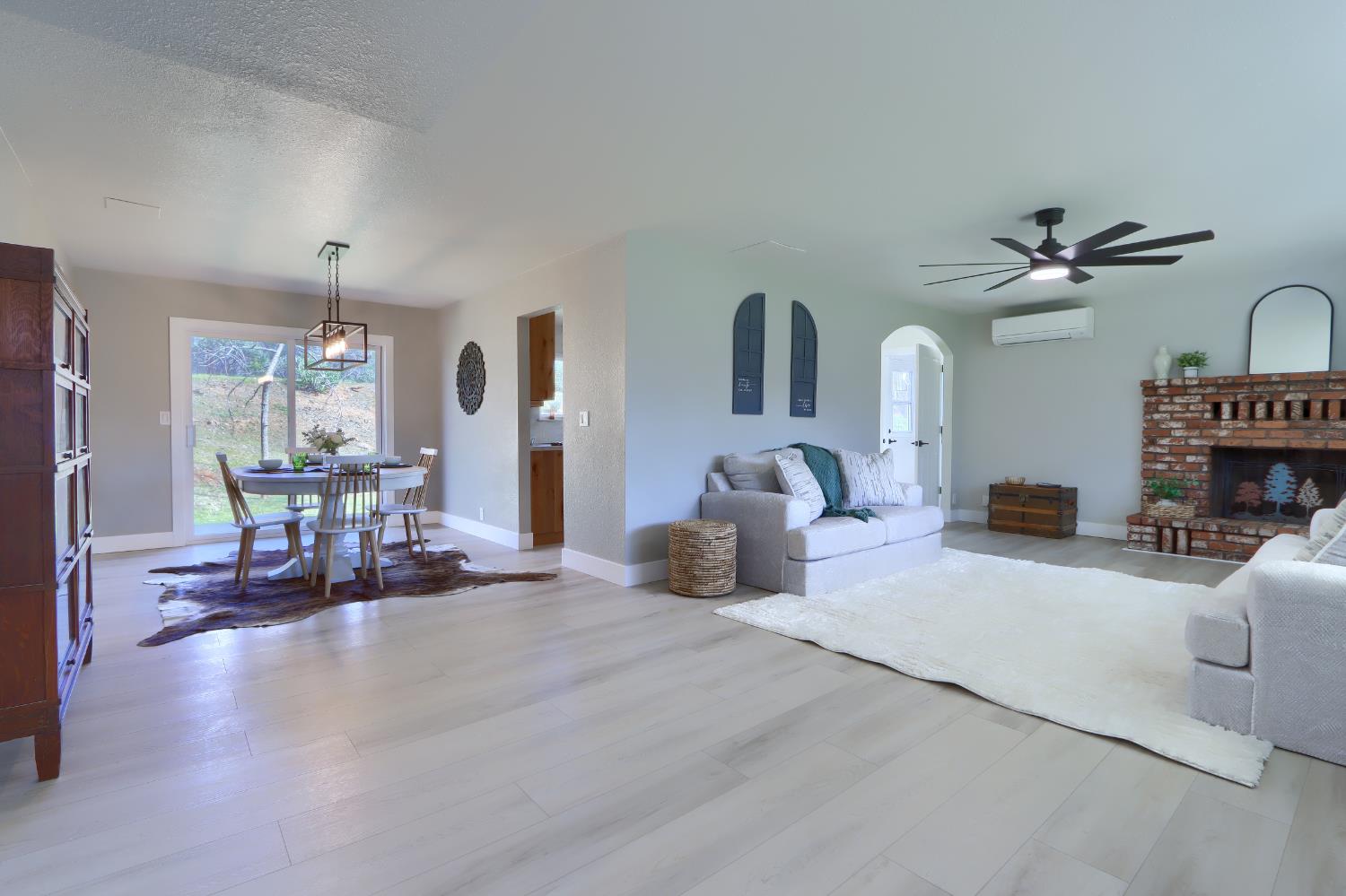 5518 East Whitlock Road Mariposa, CA 95338 - Photo 12 of 57 a living room with furniture and a chandelier