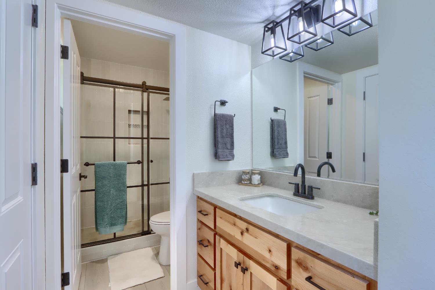 5518 East Whitlock Road Mariposa, CA 95338 - Photo 31 of 57 a bathroom with a double vanity sink and a mirror