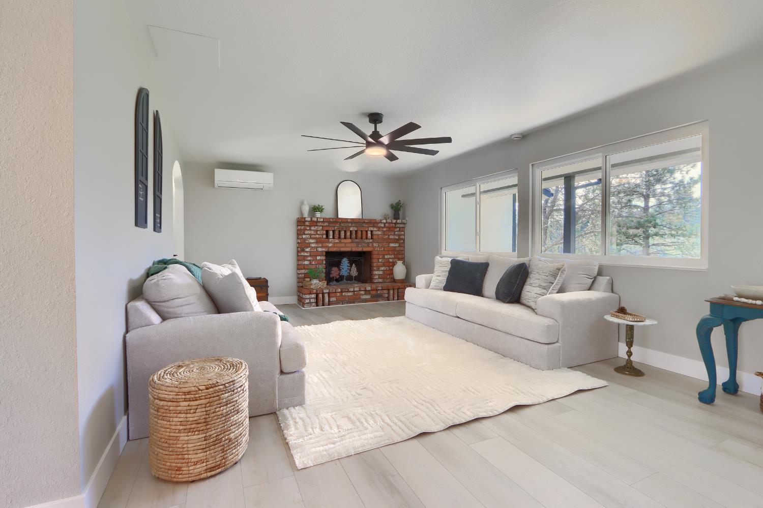 5518 East Whitlock Road Mariposa, CA 95338 - Photo 8 of 57 a living room with furniture a fireplace and a chandelier